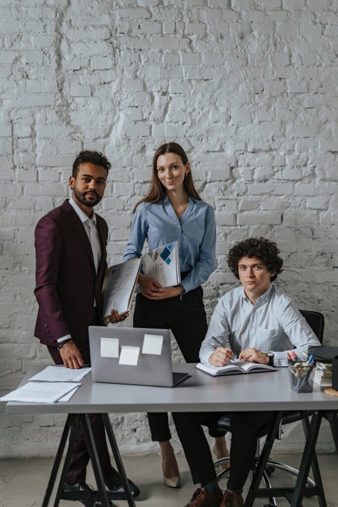 Men and a Woman Smiling and Posing